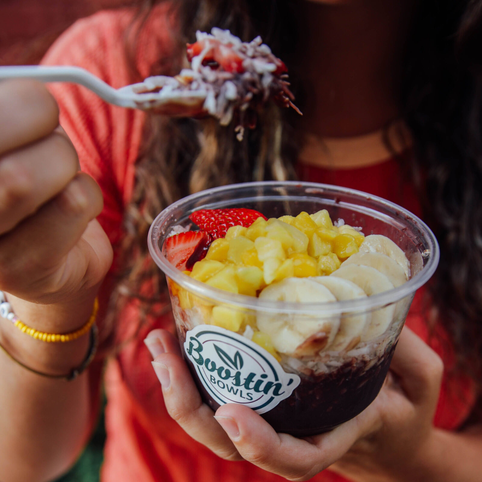 A spoonful of açaí lifted from a bowl