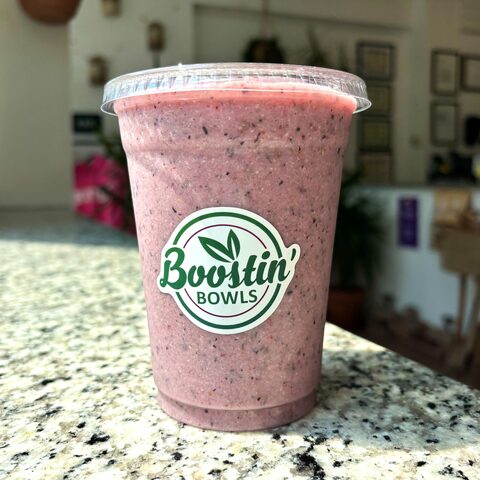 Pink smoothie with banana, berries, chia, hemp seeds, and honey