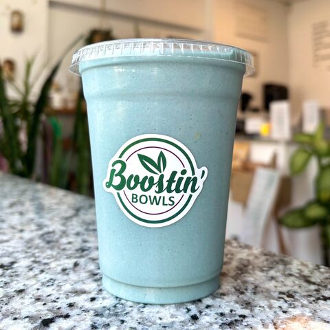 Blue-green smoothie with banana, mango, pineapple, almond milk, blue spirulina, and peanut butter
